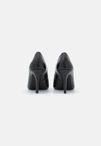 Black leather high heels with pointed toes and slender stiletto heels. Smooth texture with subtle detailing along the seams.