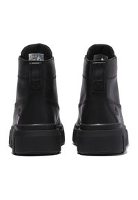 Black leather ankle boots featuring a high-top design, textured surface, thick rubber sole, and stitched accents on the heel.