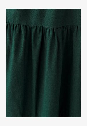 Dark green fabric featuring a gathered texture at the seam, with a smooth finish and subtle sheen. No visible patterns or additional details.