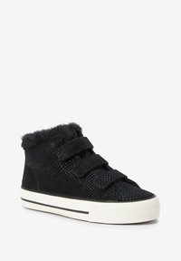 Black high-top sneakers with a textured upper, faux fur collar, and two Velcro straps, featuring a white rubber sole with a black stripe.