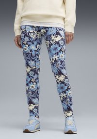 Leggings met een bloemenpatroon in blauw, marineblauw en crème. Gemaakt van rekbare stof, voorzien van een hoge taille en een logodetail.