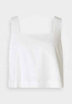 Balti lininis trumpas viršus su kvadratiniu dekolltė, plačiomis petnešomis ir laisvu siluetu, turintis lygų paviršių ir švarų apdailą.