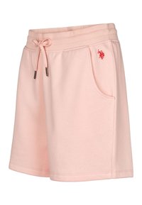 Světle růžové krátké tepláky s páskem se stažením v pase, bočními kapsami a malým červeným vyšívaným logem vpředu. Měkký bavlněný materiál.