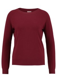 Pull en tricot bordeaux à manches longues et col rond. Texture lisse avec détail de bord côte au bas. Sans motifs ni ornements.