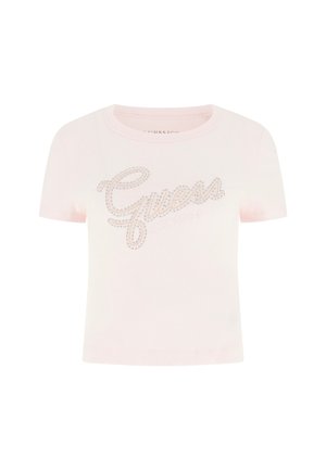 T-shirt rosa chiaro a costine con maniche corte, decorata con il logo "Guess" in strass sul petto e con scollo rotondo.