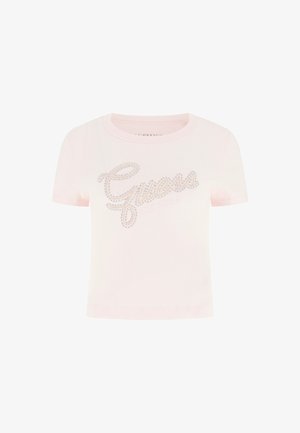T-shirt rosa chiaro a costine con maniche corte, decorata con il logo "Guess" in strass sul petto e con scollo rotondo.