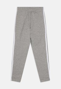 Szare dresy wykonane z miękkiego materiału z białym paskiem po każdej stronie. Posiadają elastyczny pasek w talii oraz zwężane nogawki.