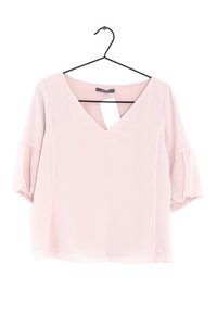 Roze blouse met korte mouwen, een V-hals en pofmouwen, met een gladde textuur en een rechte zoom. Hangt aan een zwarte haak.