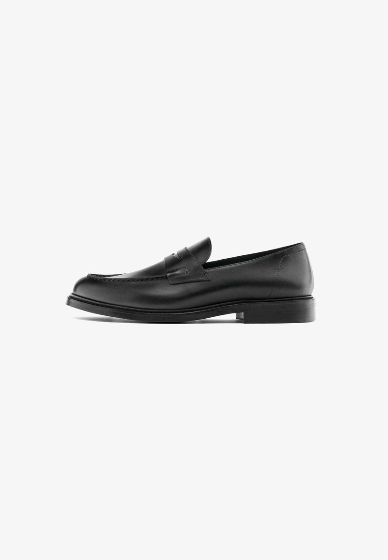 Black leather penny loafer with low heel, rounded toe, and stitched detail along the upper, shown in side profile on a white background.