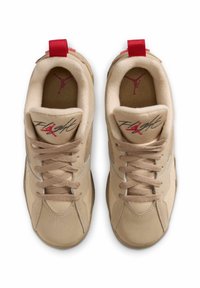 Beige athletic shoes with mesh panels, red accents, and textured laces. Features "Flight" script and a logo on the tongue. Flat rubber sole.
