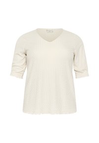 Haut crème à manches courtes avec un col en V et un motif en diamant texturé. L'ourlet et les bords des manches sont légèrement effilochés pour un look décontracté.