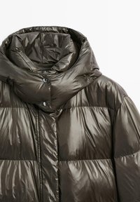 Puffer jacket in dark olive green with a glossy finish, featuring a high collar, snap closures, and stitched, quilted sections.