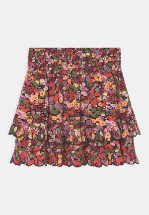 Jupe à motif floral avec taille smockée et ourlet à volants double couche dans des couleurs rouge, orange, violet, vert et rose.