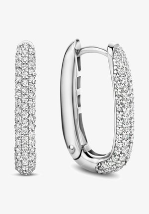 Silver hoop earrings with a curved, smooth design, featuring a surface set with multiple small, sparkling clear gemstones.