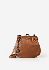 Brown leather crossbody bag with black metal clasp and chain detail featuring a black cameo charm, set against a white background.