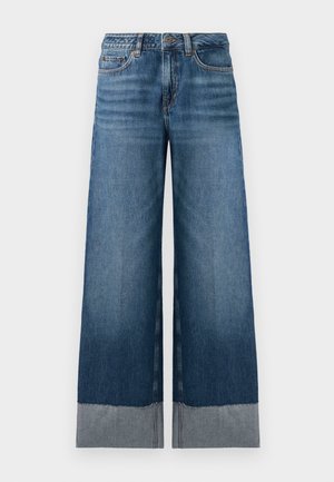 Bredde ben blå jeans med en gradient fra mørkere til lysere denim, med rå brun og subtile søm detaljer. Klassisk fem-pocket design.