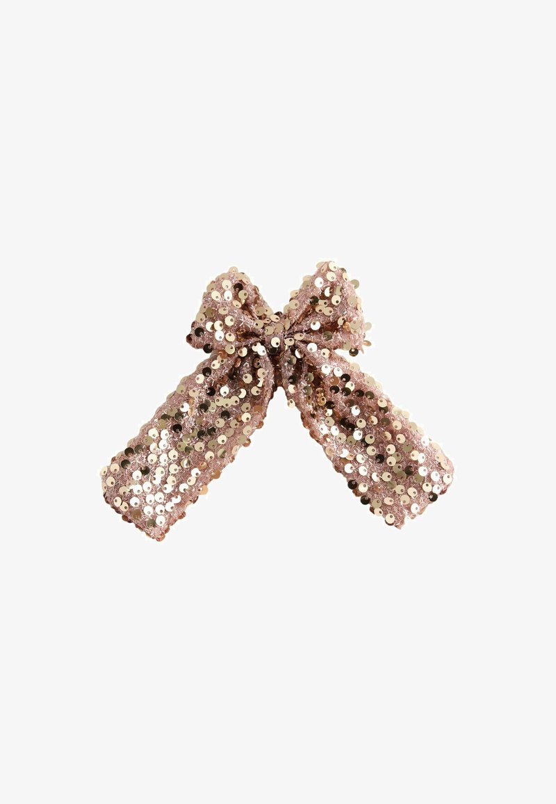 Fiocco di paillettes rosa scintillanti con due lunghe code, accessorio decorativo su uno sfondo bianco.