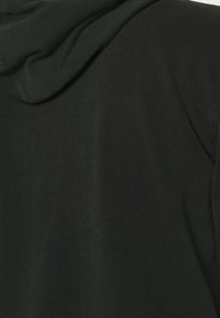 Black hoodie featuring a soft cotton blend, relaxed fit, and adjustable drawstring at the hood. Seam detailing along the shoulders.