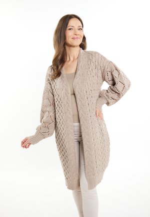 Cardigan lungo beige con un motivo a maglia testurizzato, caratterizzato da un'apertura frontale, maniche oversize e polsini a costine per un tocco di dettaglio.