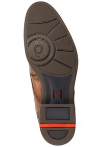 Brauner Lederschuhsohle mit einem kreisförmigen Logo, strukturiertem Gummi-Griff und roten Akzenten. Verfügt über tiefe Rillen und einen flachen Absatz für Stabilität.
