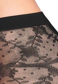 Collant neri a motivo con un design floreale e pois, dotati di una fascia in vita nera liscia per il comfort e una texture trasparente.