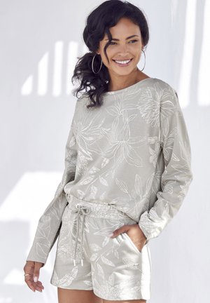 Light gray loungewear set featuring long-sleeve top and shorts with white floral patterns. Drawstring waistband and side pockets.