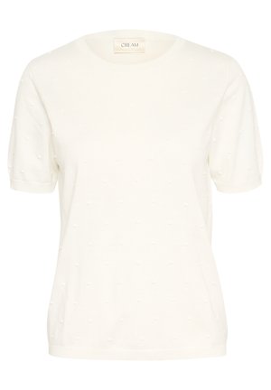 Bílý krátký rukáv pletený top s texturovaným tečkovaným vzorem, kulatým výstřihem a volným střihem. Na štítku je nápis "CREAM."