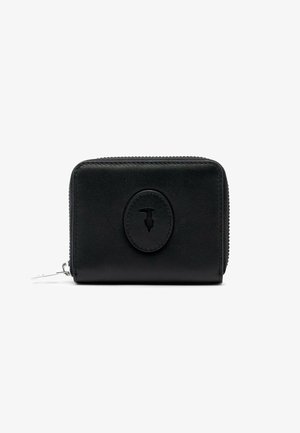 Cartera compacta de cuero negro con cierre de cremallera y una placa de logo ovalada cosida centrada en el frente.