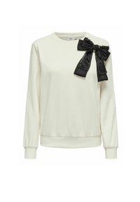 Felpa crema con polsini e orlo a costine, caratterizzata da un grande fiocco in satin nero con dettagli in strass sulla spalla sinistra.
