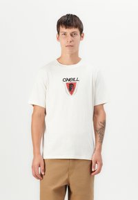 White cotton t-shirt featuring a circular red logo design with text and a face graphic. Short sleeves and crew neckline.