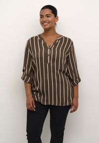 Brown and cream striped blouse with a V-neck, three-quarter sleeves, and a relaxed fit. Soft fabric with light sheen and rolled cuffs.