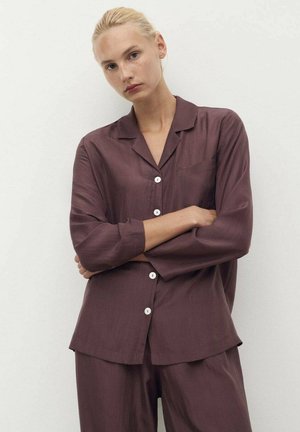 Maroon button-up shirt made of smooth fabric, featuring a notched collar, long sleeves, and a chest pocket. Paired with matching pants.