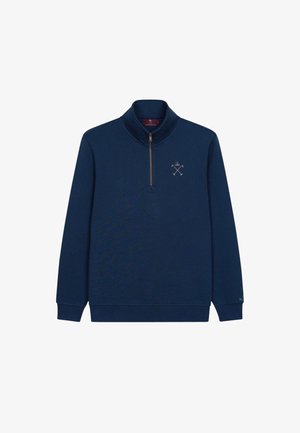 Marineblauer Pullover mit einem halben Reißverschluss am Kragen, versehen mit einem kleinen gestickten Logo auf der Brust und gerippten Bündchen. Weicher, strukturiertes Material.