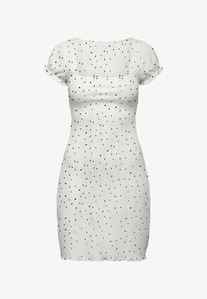 Robe blanche ajustée à manches courtes avec des pois noirs irréguliers et un col carré, avec de légers détails à volants sur les manches et l'ourlet.