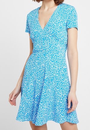 Short-sleeve blue dress with a v-neckline, featuring a white dot pattern and a flared skirt. Made of lightweight fabric.