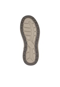 Semelle en caoutchouc avec un centre beige au grip texturé, entourée d'un bord gris foncé et d'un motif de semelle pour l'adhérence.