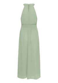Light green halter dress with a smocked waist, flowing skirt, and keyhole back detail. Made from soft, lightweight fabric.