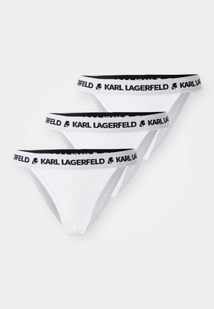 Ensemble de lingerie thong blanc avec des ceintures élastiques noires portant le logo "KARL LAGERFELD". Trois pièces présentées, avec une texture de tissu lisse.