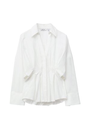 Biała bawełniana bluzka z kołnierzykiem, długimi rękawami oraz marszczeniami z przodu, tworzącymi z jednej strony strukturę, a z drugiej lekkość i swobodę.