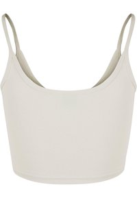 Bralette beige clair avec de fines bretelles spaghetti. Tissu lisse et extensible avec un encolure arrondie et un design minimaliste.
