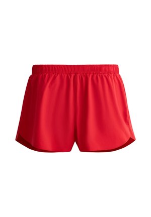 Shorts de sport rouges avec taille élastique et poches latérales, conçus pour un usage actif.