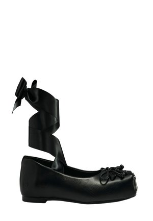 Crna baletna baletanka sa kvadratnim prstom, ukrasnom mašnom i perlicama sprijeda, te dugom satenskom trakom za vezanje oko gležnja.