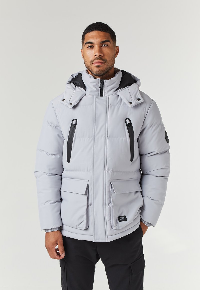 Light gray, insulated jacket with a high collar, adjustable hood, dual front pockets, and black zippers and accents.