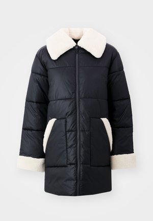 Μαύρο μπουφάν puffer με αφράτο κρεμ λαιμό, κρεμ λεπτομέρειες στις τσέπες και τα μανίκια, με μπροστινό φερμουάρ και στιλ κεντητού σχεδιασμού.