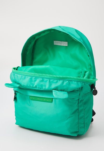 Green nylon backpack featuring a double-zippered main compartment, exterior pocket, and embossed brand tag. Smooth, lightweight texture.