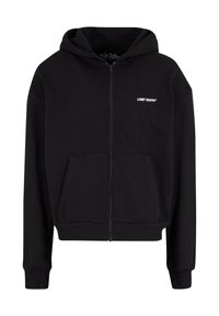 Svart zip-up hoodie i mjukt material, med en framficka, ribbade ärmslut och en liten vit logotyp "LOST YOUTH" på bröstet.