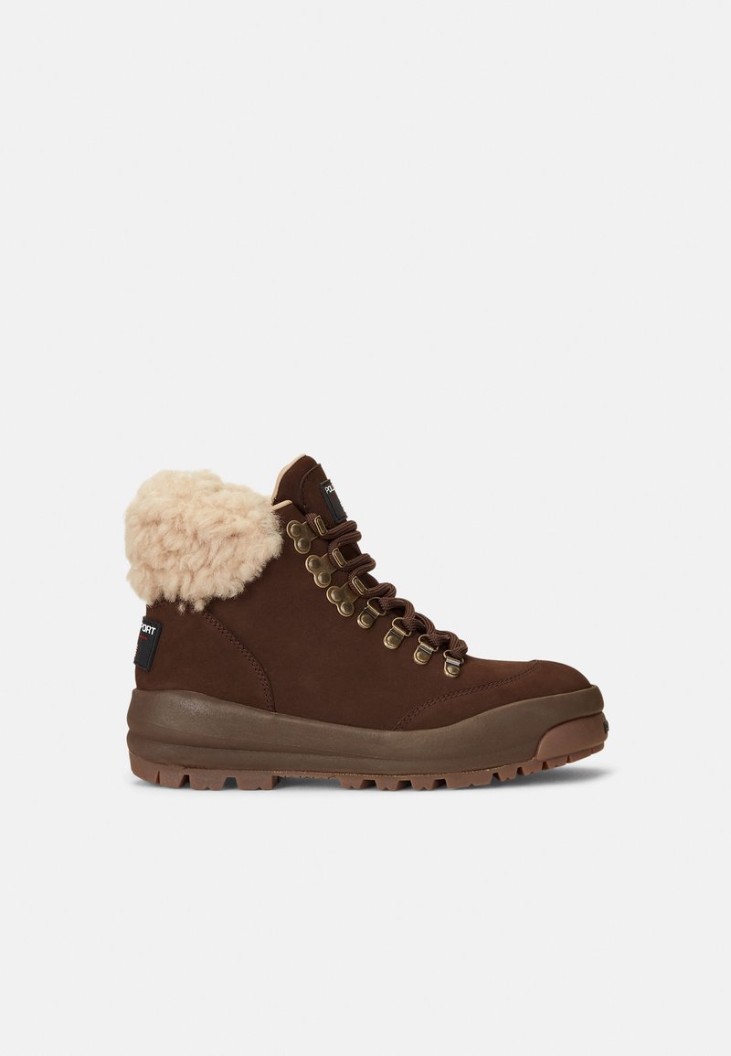 Brown hiking boot with light tan fleece collar, metal eyelets, rugged sole, and black fabric tag on heel, viewed from the side against a white background.