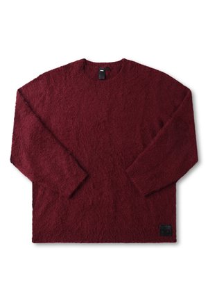 Bordeauxrode trui met lange mouwen, gemaakt van zacht, gestructureerd materiaal. Ronde hals, losse pasvorm, met een klein zwart logo op de zoom.