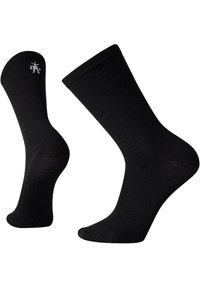 Schwarze Crew-Socken aus glattem Stoff. Mit einem gerippten Bund und einem kleinen, dezenten Logo in der Nähe des Knöchels. Klassisches, vielseitiges Design.