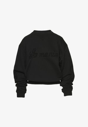 Czarna skrócona bluza z ribbowym dekoltem i mankietami. Haftowany napis "La mania" w lekko wypukłej strukturze. Gładka tkanina.